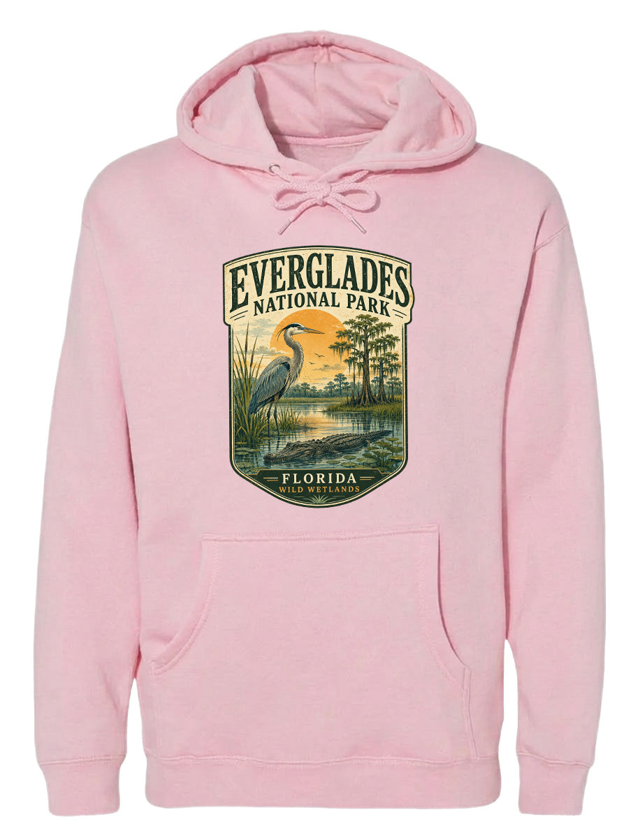 A pink hoodie with a graphic design depicting a bird and a landscape scene, along with the text "EVERGLADES NATIONAL PARK FLORIDA".