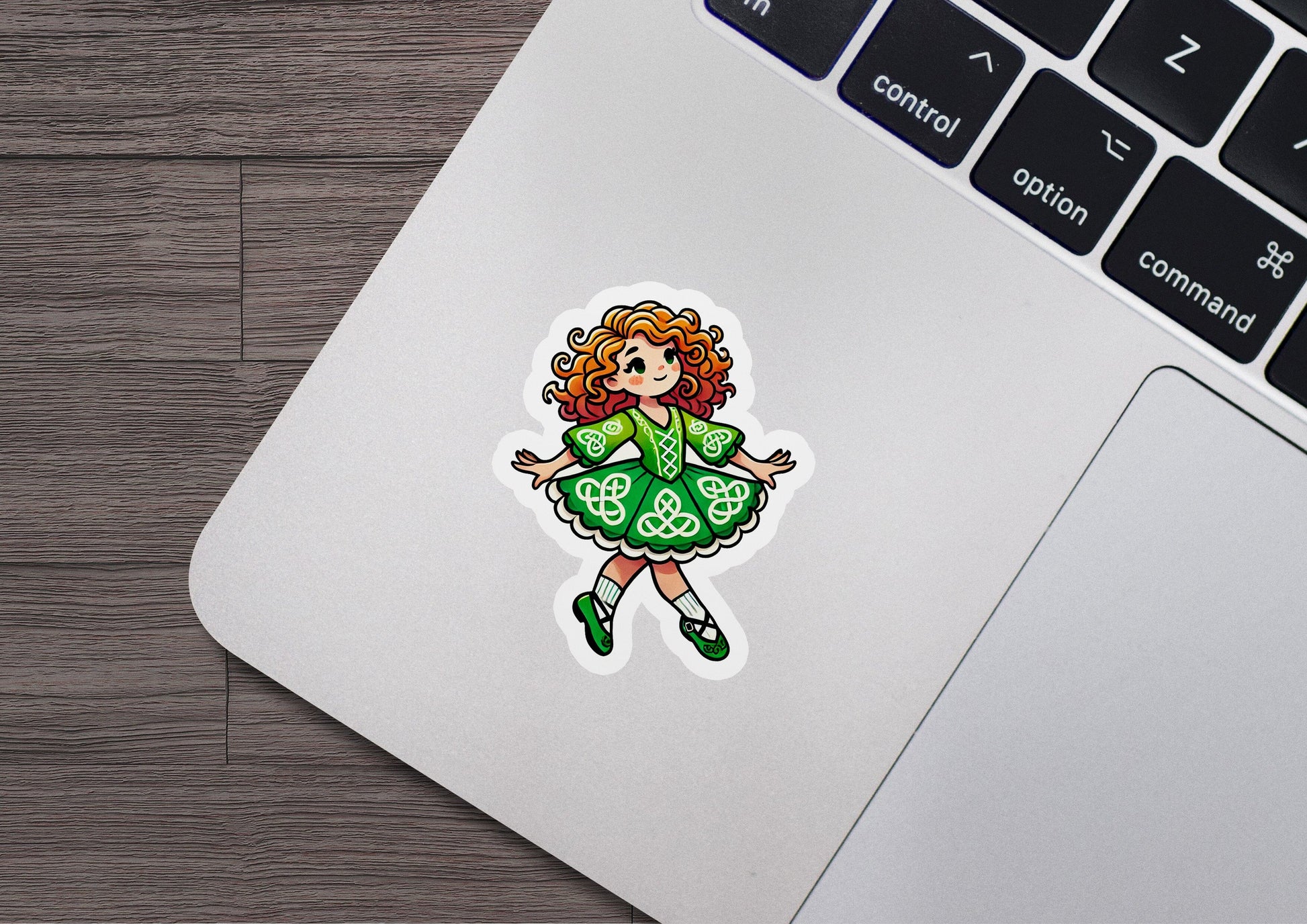 a laptop with a sticker of a girl in a green dress