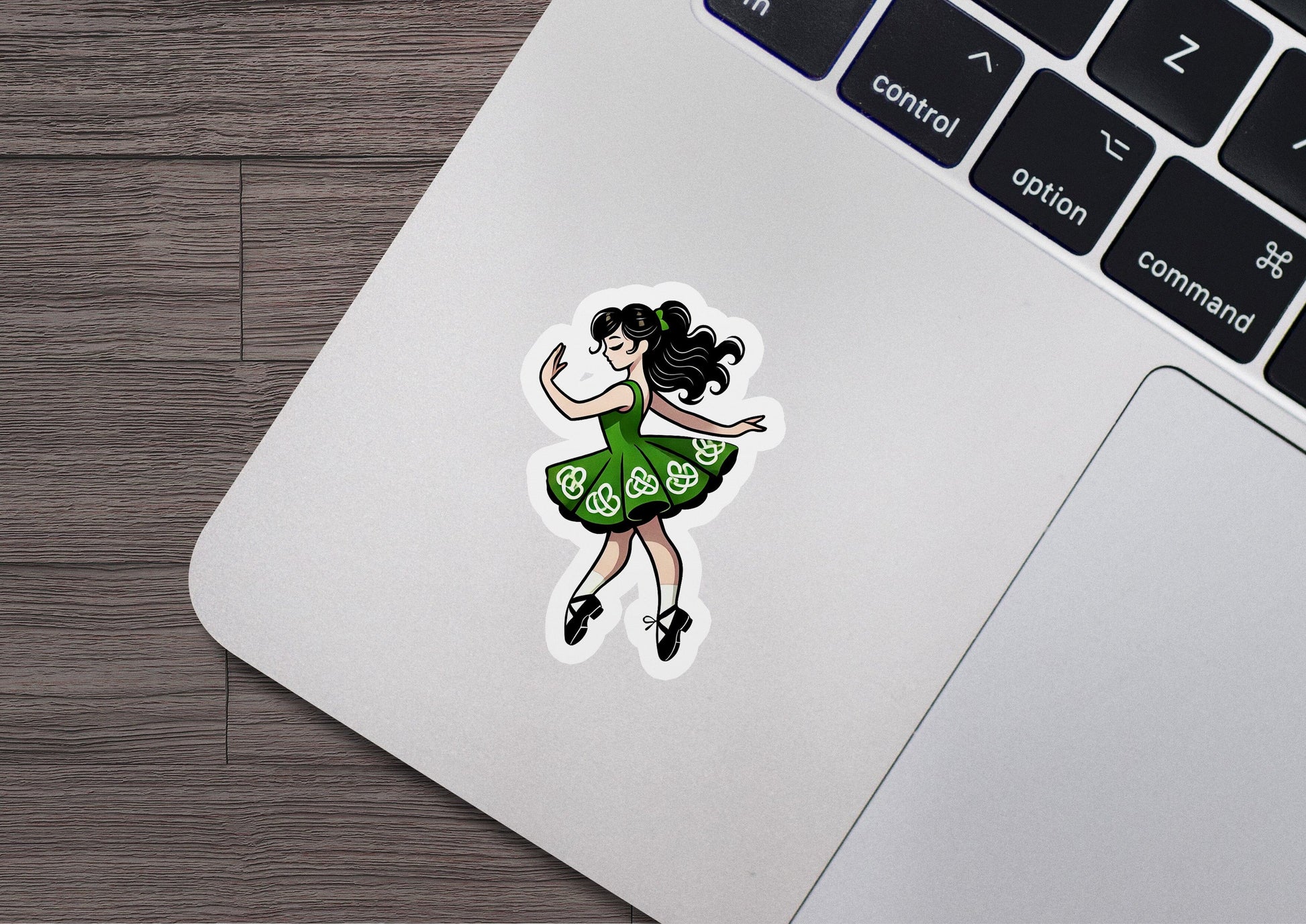 a laptop with a sticker of a woman dancing