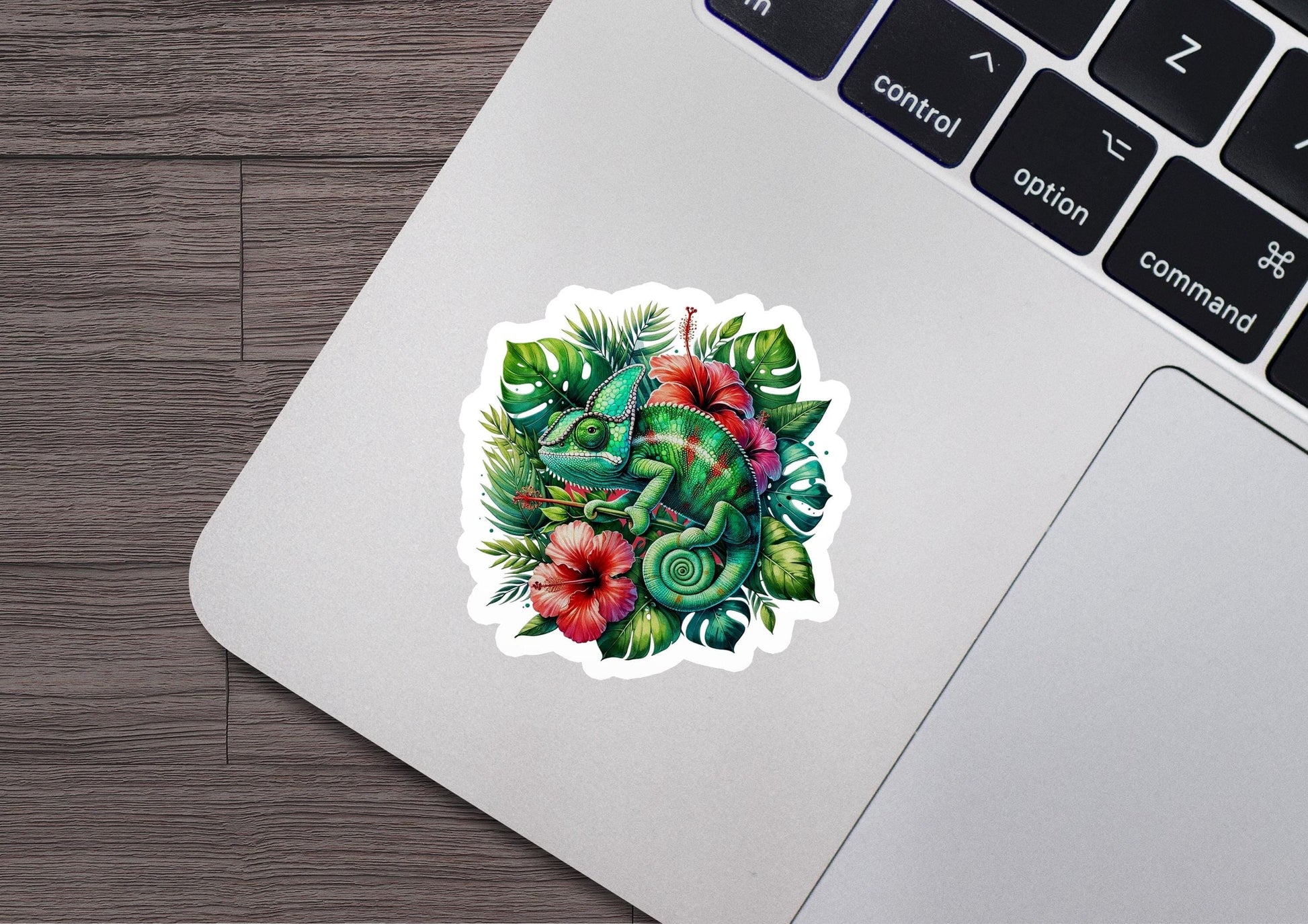 a laptop with a sticker of an elephant surrounded by flowers