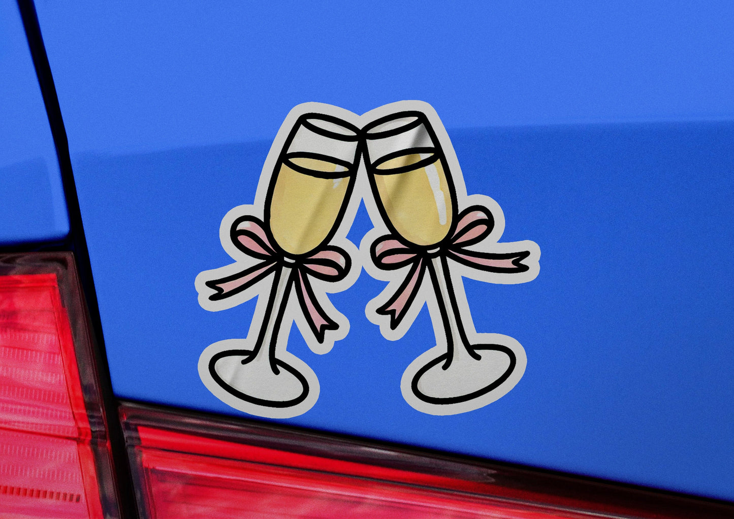a pair of champagne flutes sticker on the back of a car