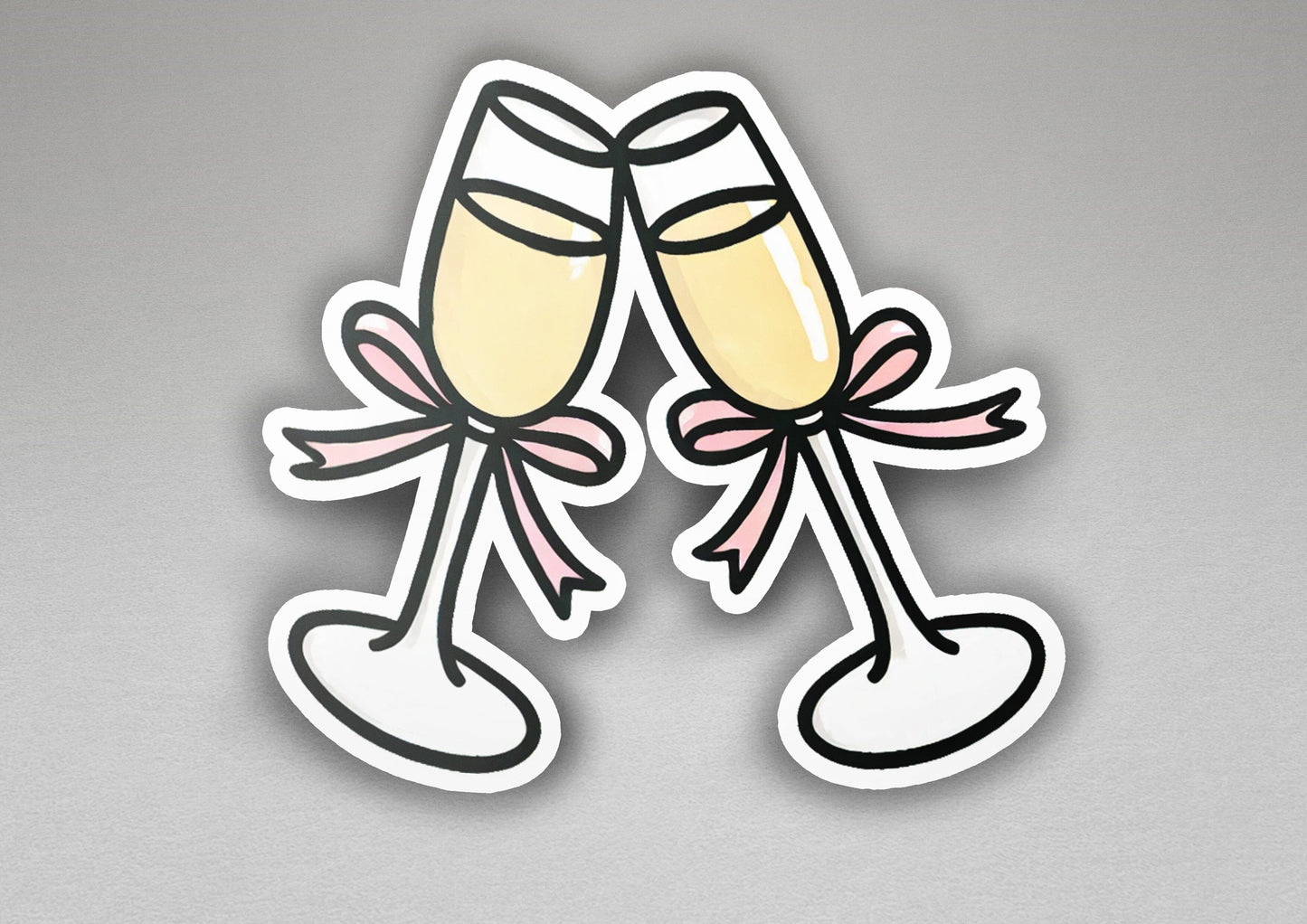a pair of champagne flutes with a pink bow