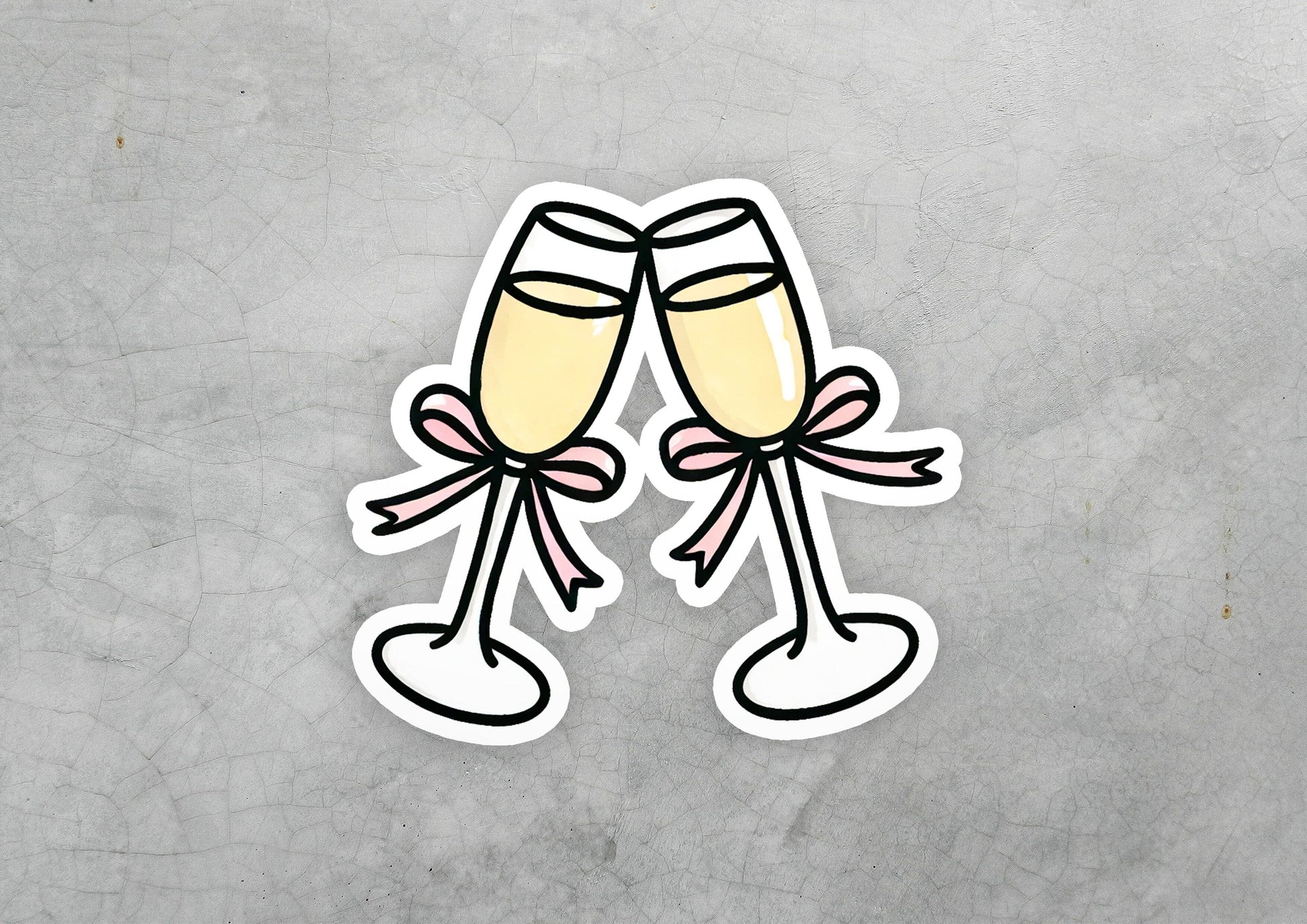 a pair of champagne glasses with a bow on a gray background