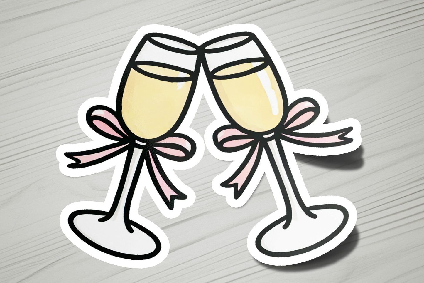a pair of glasses of champagne stickers on a table