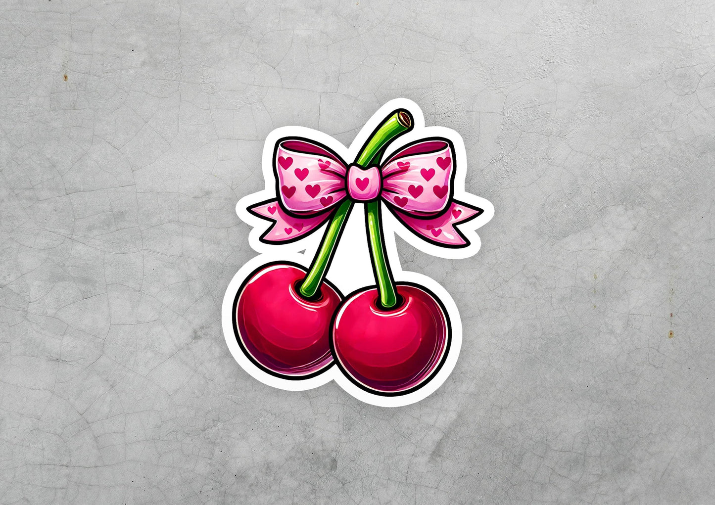 a sticker of two cherries with a bow