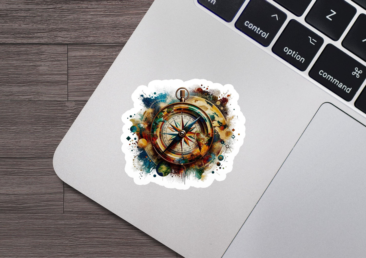 a laptop with a sticker of a compass