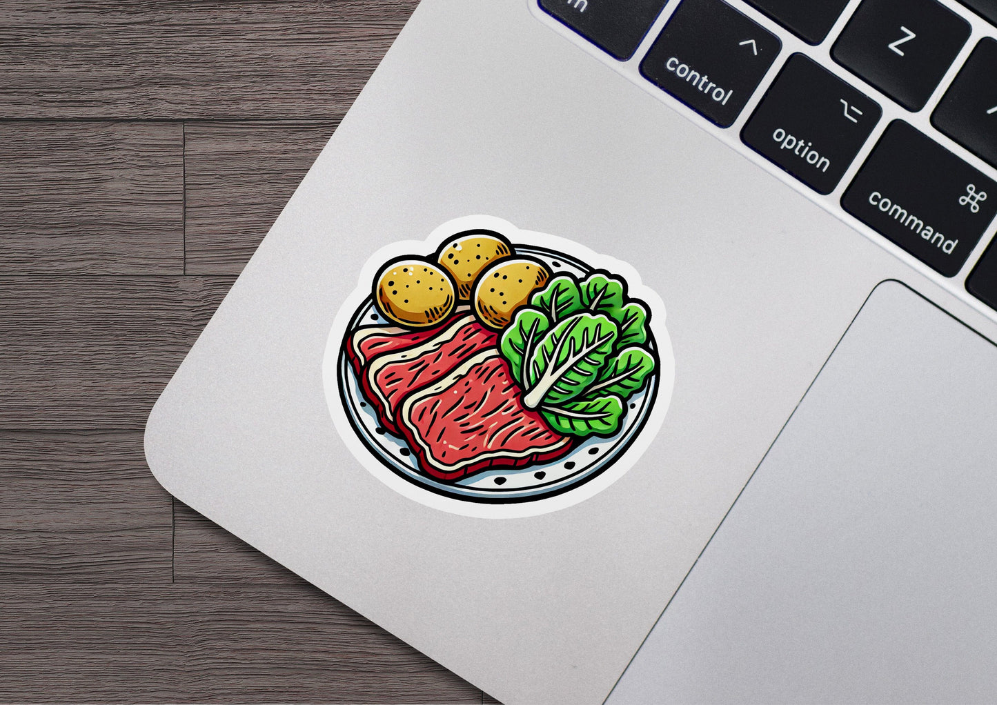 a sticker of meat and vegetables on a laptop