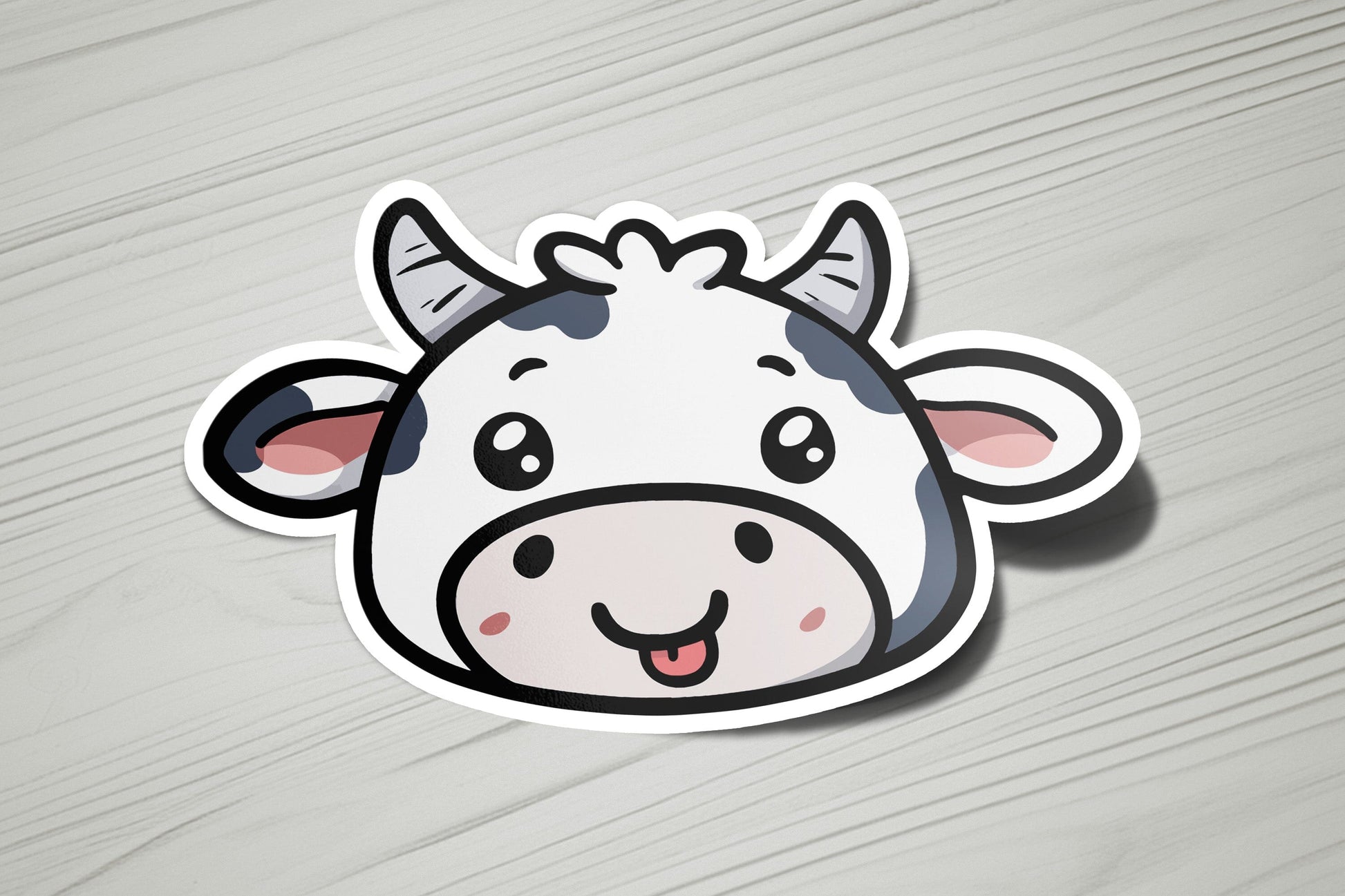 a sticker of a cow on a wooden surface