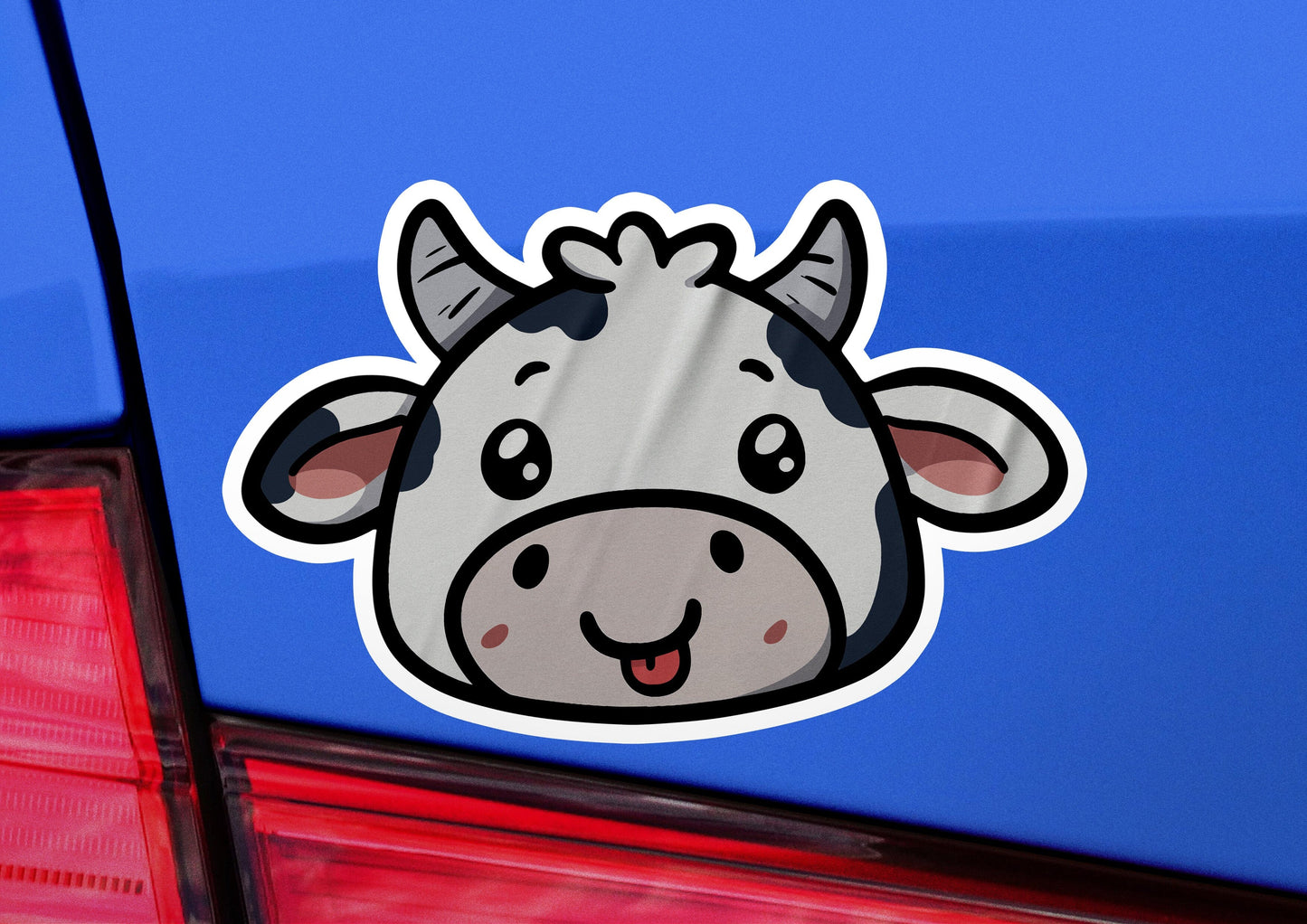 a sticker of a cow's head on the back of a car
