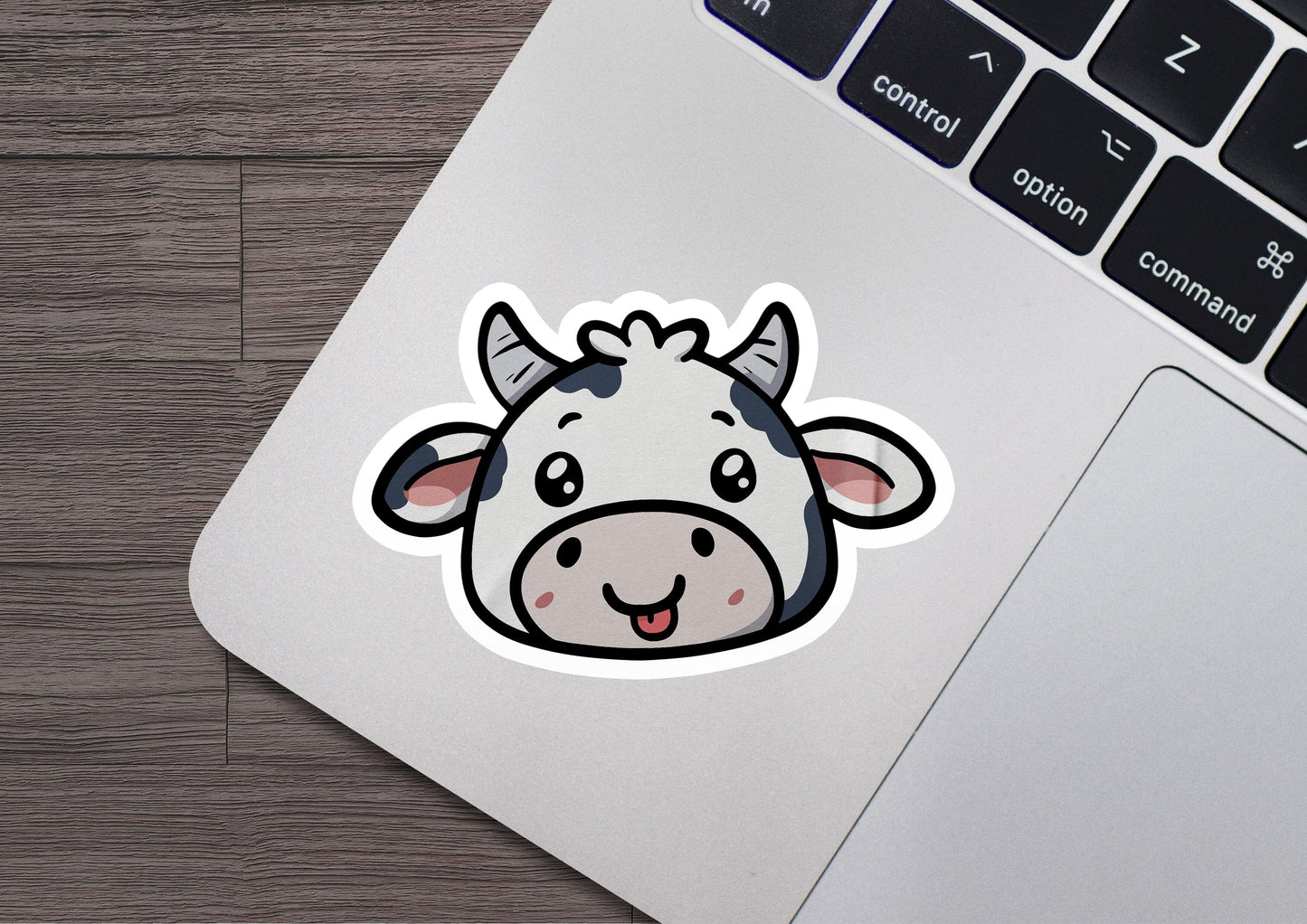 a sticker of a cow on a laptop