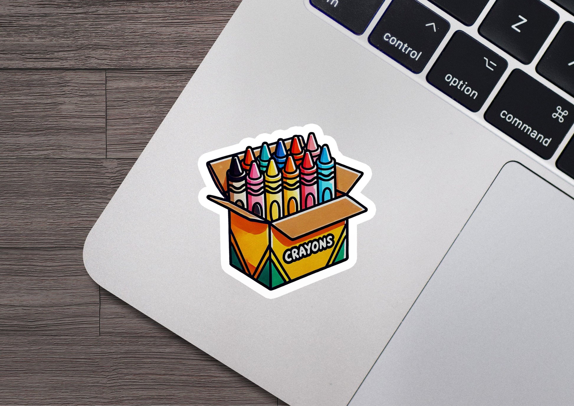 a laptop with a sticker of a box of crayons