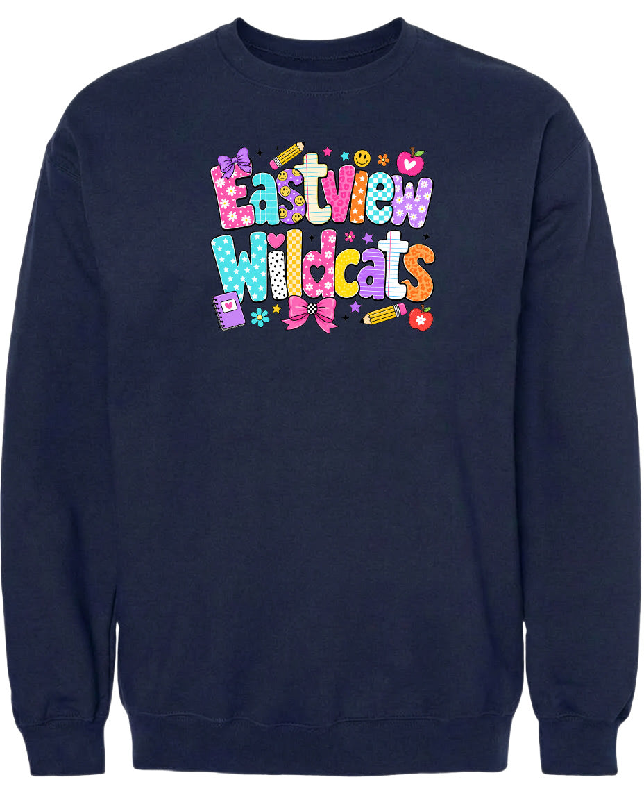 A navy blue sweatshirt with a colorful, playful design featuring the text "Eastview Wildcats" and various decorative elements such as hearts, stars, and flowers.
