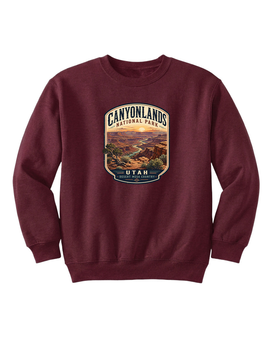 A burgundy-colored sweatshirt with a graphic design depicting the scenic landscape of Canyonlands National Park in Utah.