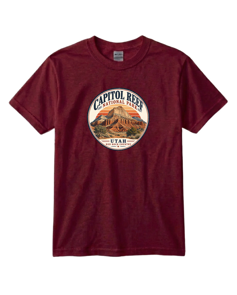 A burgundy-colored t-shirt with a circular graphic design featuring the Capitol Reef National Park in Utah.