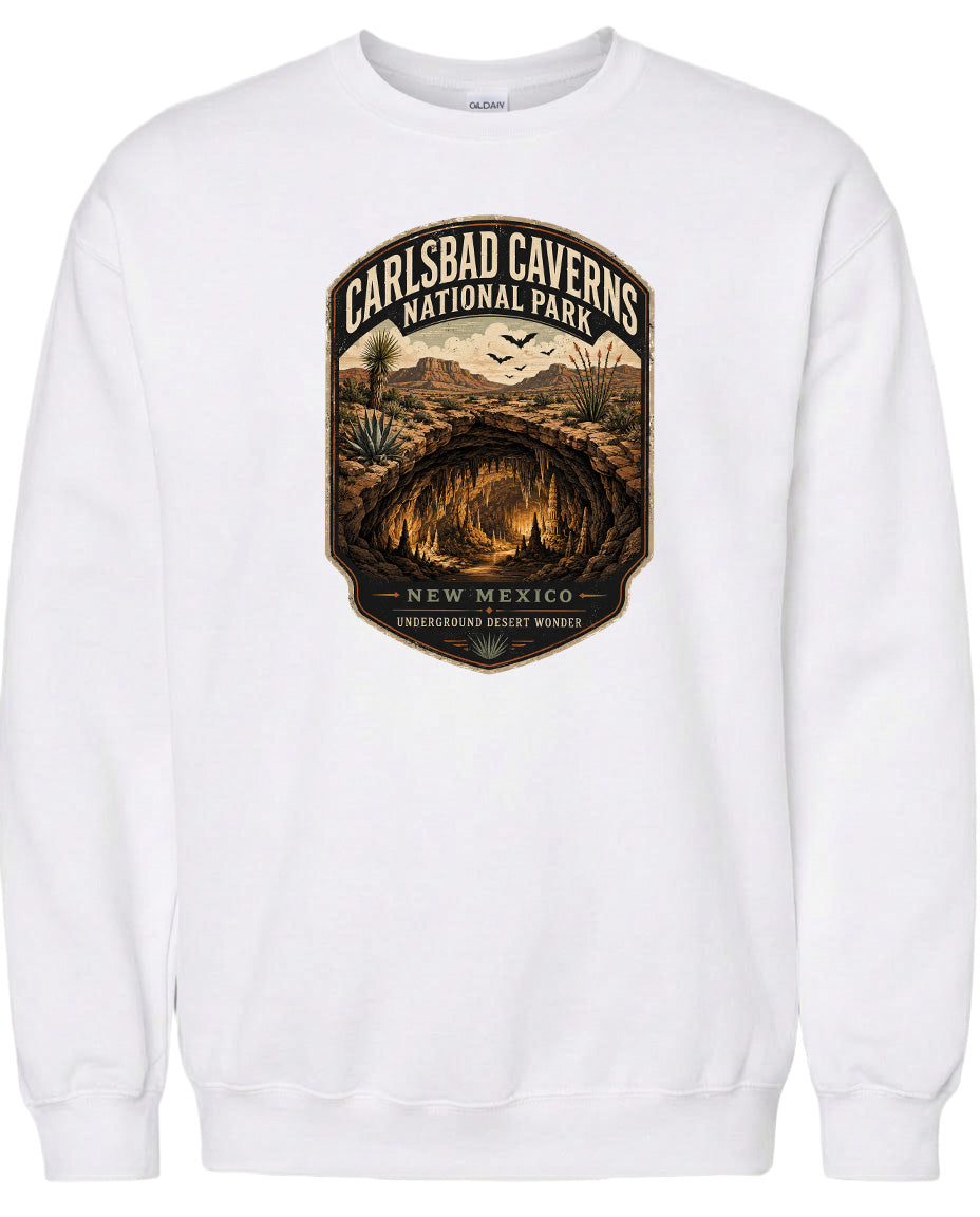 A white sweatshirt with a graphic design depicting the Carlsbad Caverns National Park in New Mexico.