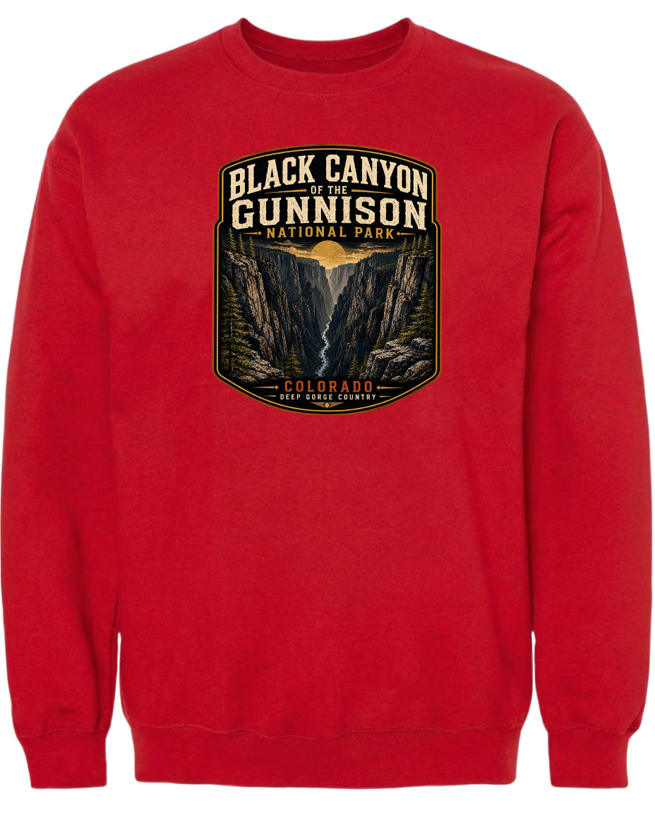 A red sweatshirt with a graphic design depicting the Black Canyon of the Gunnison National Park in Colorado.