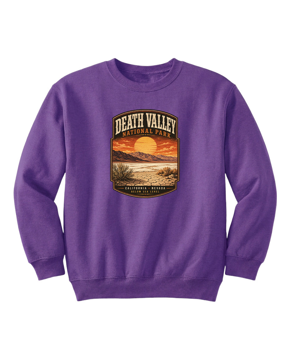 A purple sweatshirt with a graphic design depicting a sunset over Death Valley National Park.