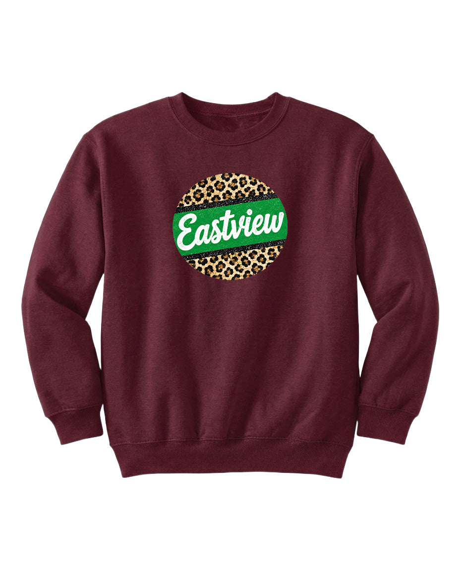 A burgundy sweatshirt with a green and leopard print circular logo on the front.