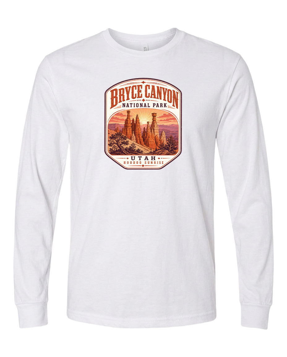 A white long-sleeved t-shirt with a graphic design depicting the Bryce Canyon National Park in Utah.