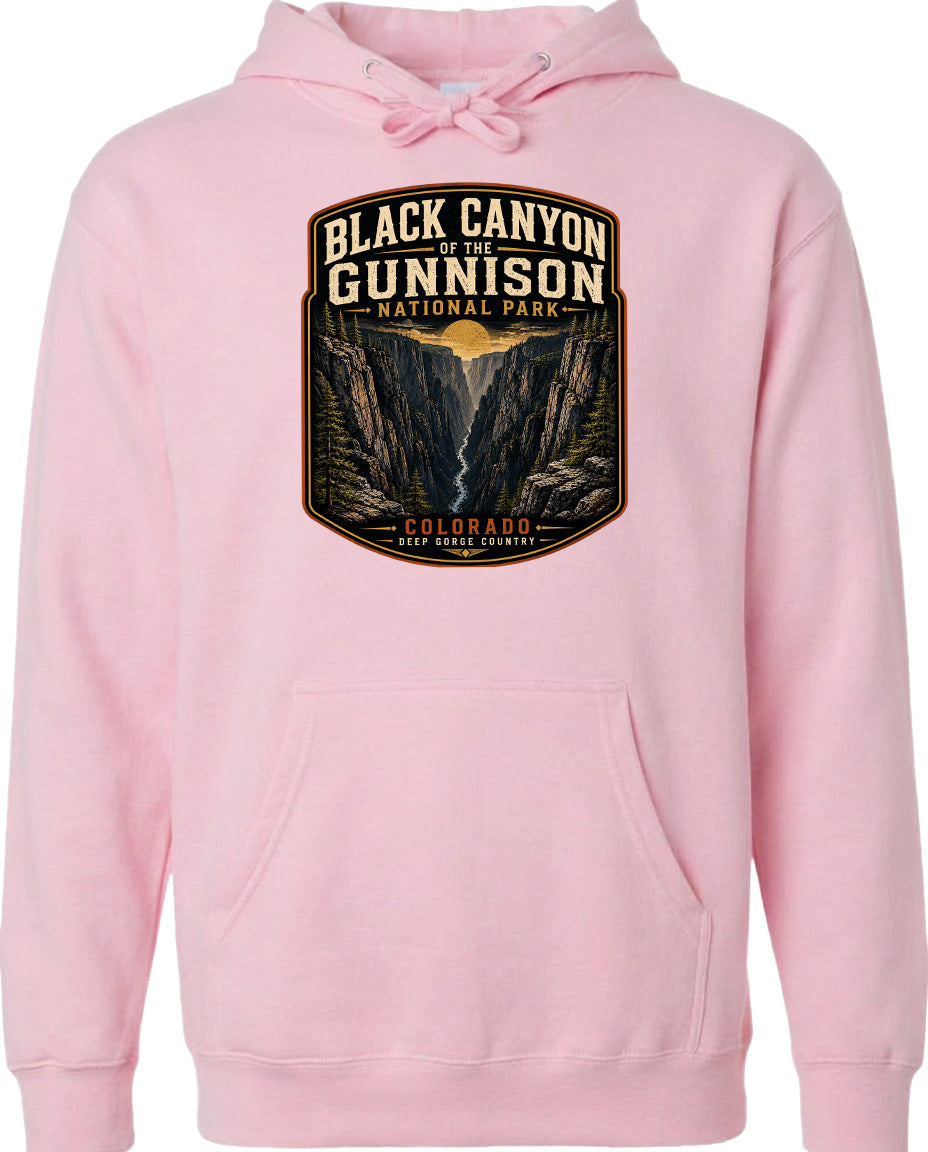 A pink hoodie with a graphic design depicting the Black Canyon of the Gunnison National Park in Colorado.