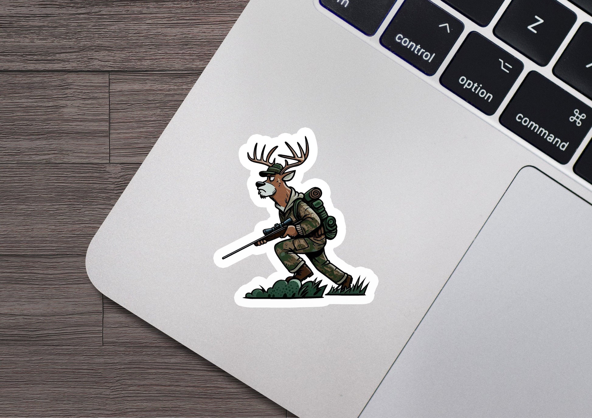 a laptop with a sticker of a deer hunter