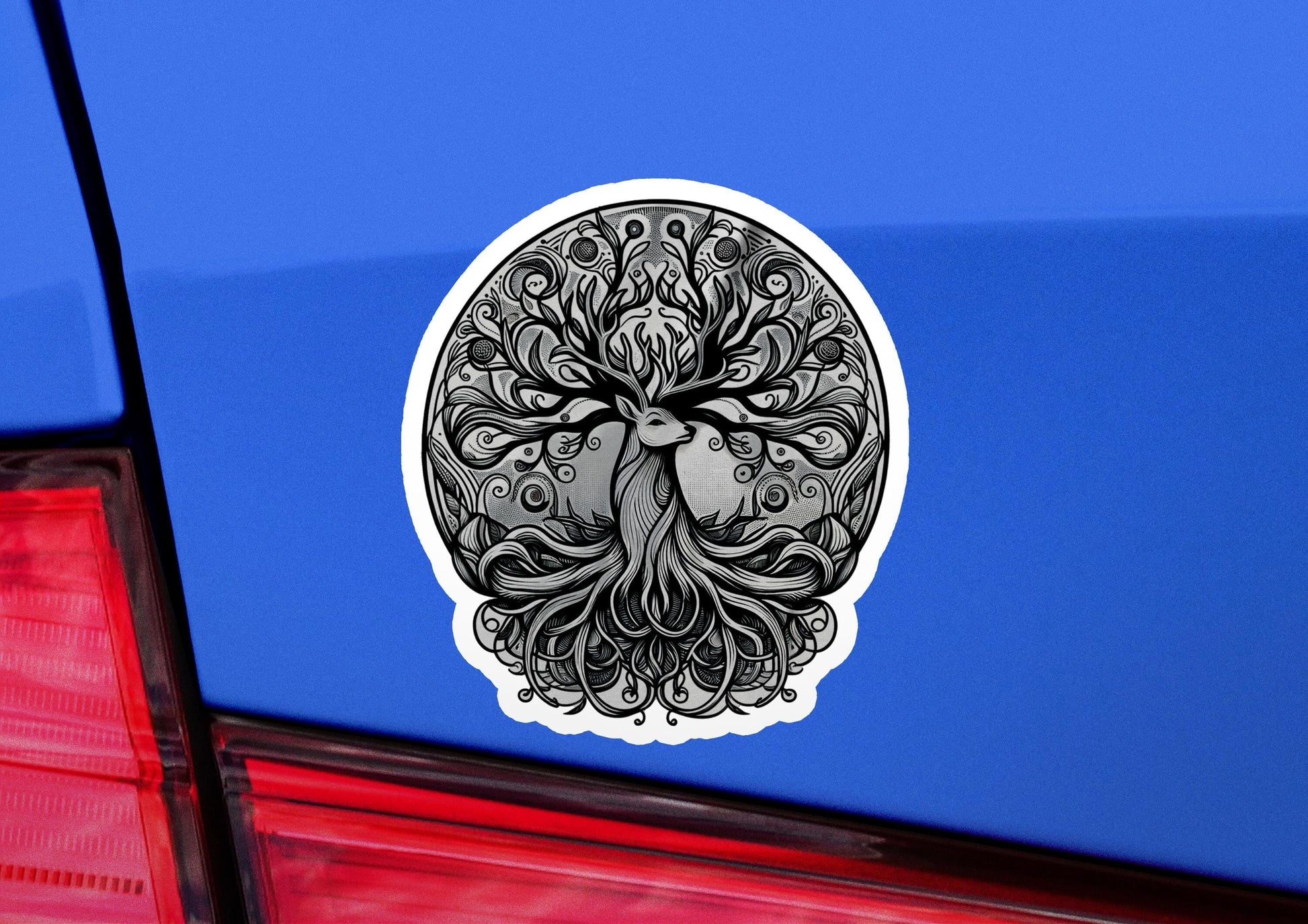a sticker of a tree of life on a blue car
