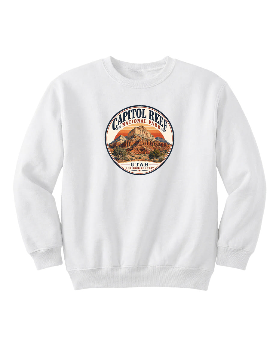 A white sweatshirt with a circular design featuring the Capitol Reef National Park logo and the text "UTAH" printed on it.