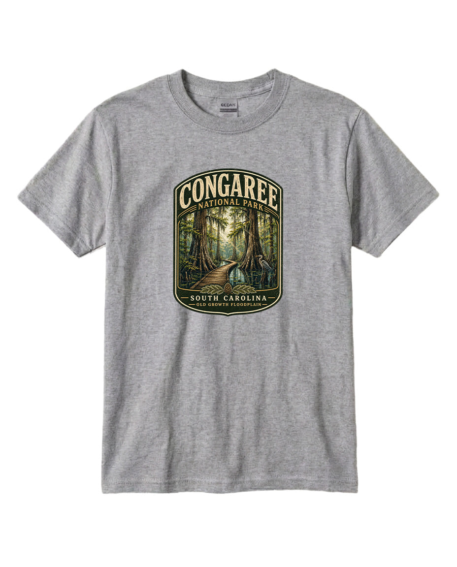 A gray t-shirt with a graphic design depicting a forest scene with a path leading through it, surrounded by trees and foliage.