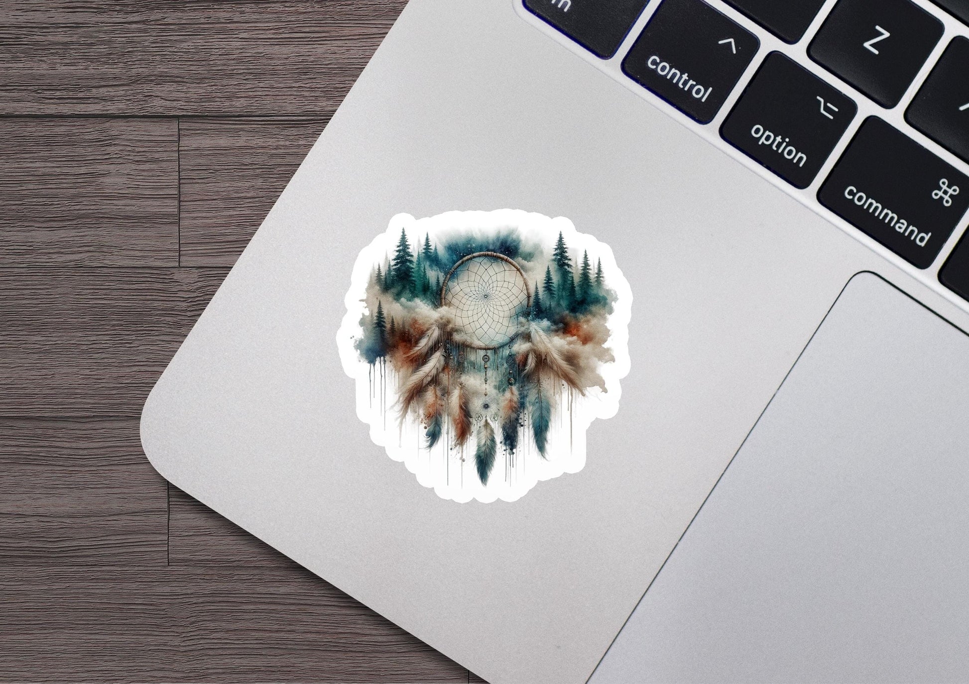 a laptop with a sticker of a dream catcher