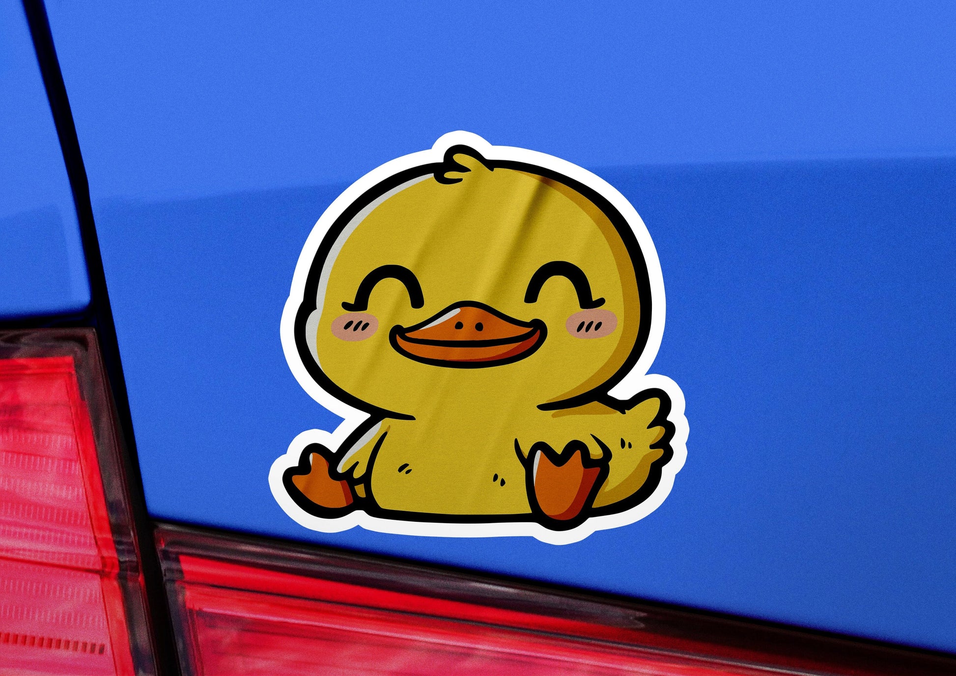 a sticker of a ducky sitting on the back of a car