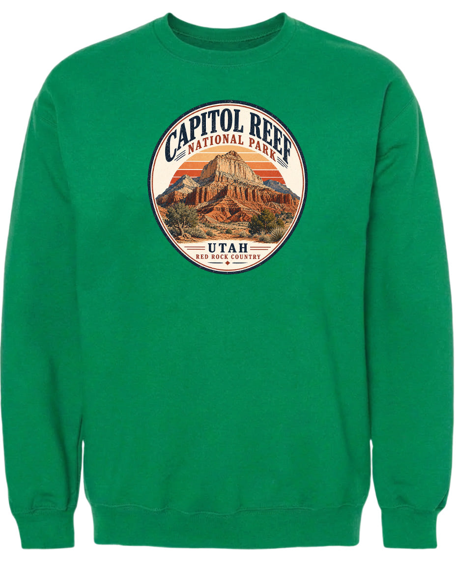 A green sweatshirt with a circular design featuring the Capitol Reef National Park in Utah.