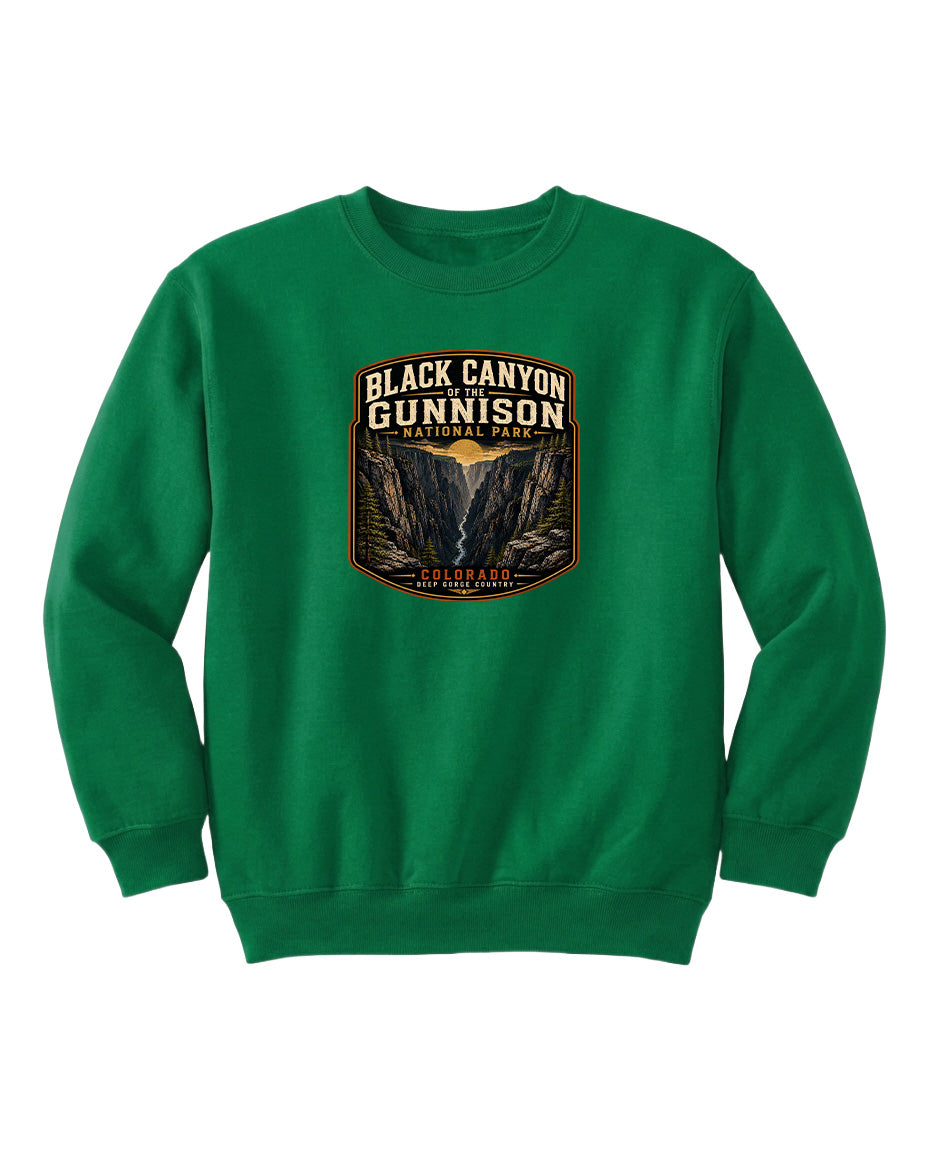 A green sweatshirt with a graphic design featuring the text "Black Canyon Gunnison National Park" and an illustration of a canyon.
