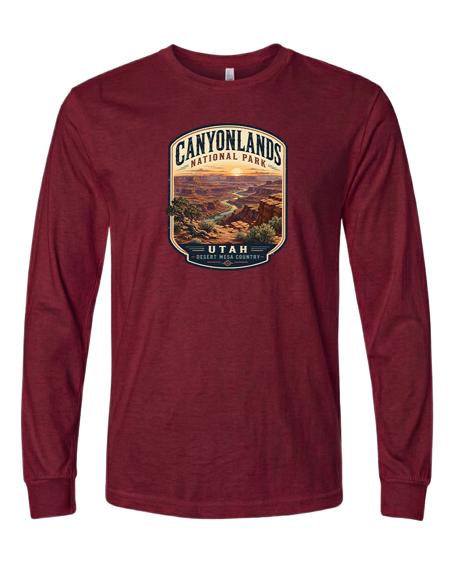 A red long-sleeved t-shirt with a graphic design depicting a scenic landscape of the Canyons National Park in Utah.