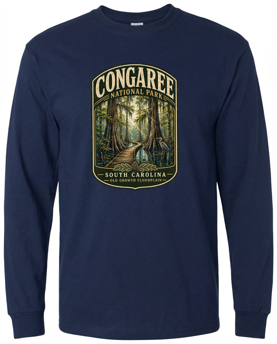A navy blue long-sleeved t-shirt with a graphic design depicting a forest scene, featuring a path leading through the trees and a bird in the distance.