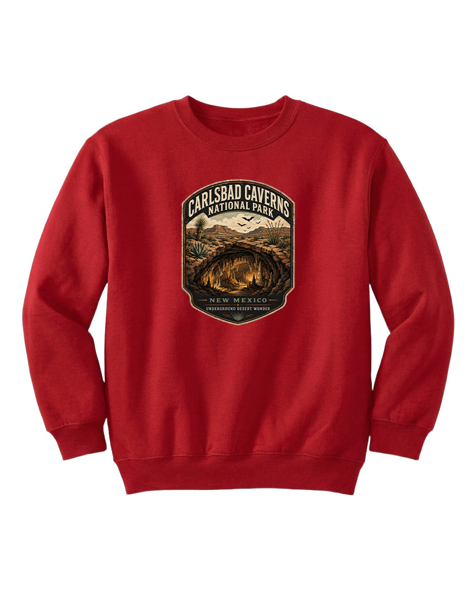 A red sweatshirt with a graphic design featuring a desert landscape and the text "CARLSBAD CAVERSNATIONAL PARK NEW MEXICO UNDERGROUND WONDER".