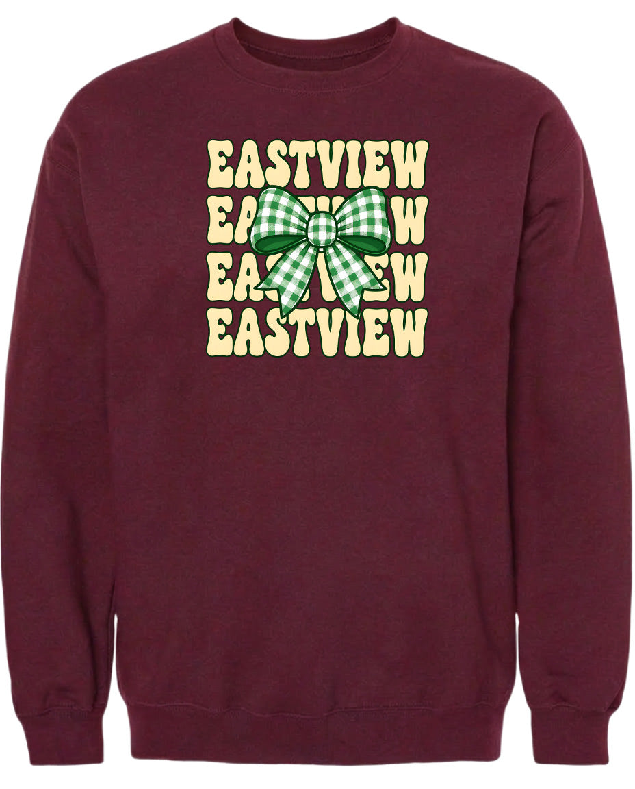 A burgundy sweatshirt with a graphic design featuring a green and white checkered bow on the front.