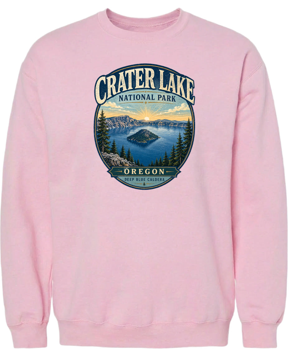 A pink sweatshirt with a graphic design depicting Crater Lake National Park in Oregon.