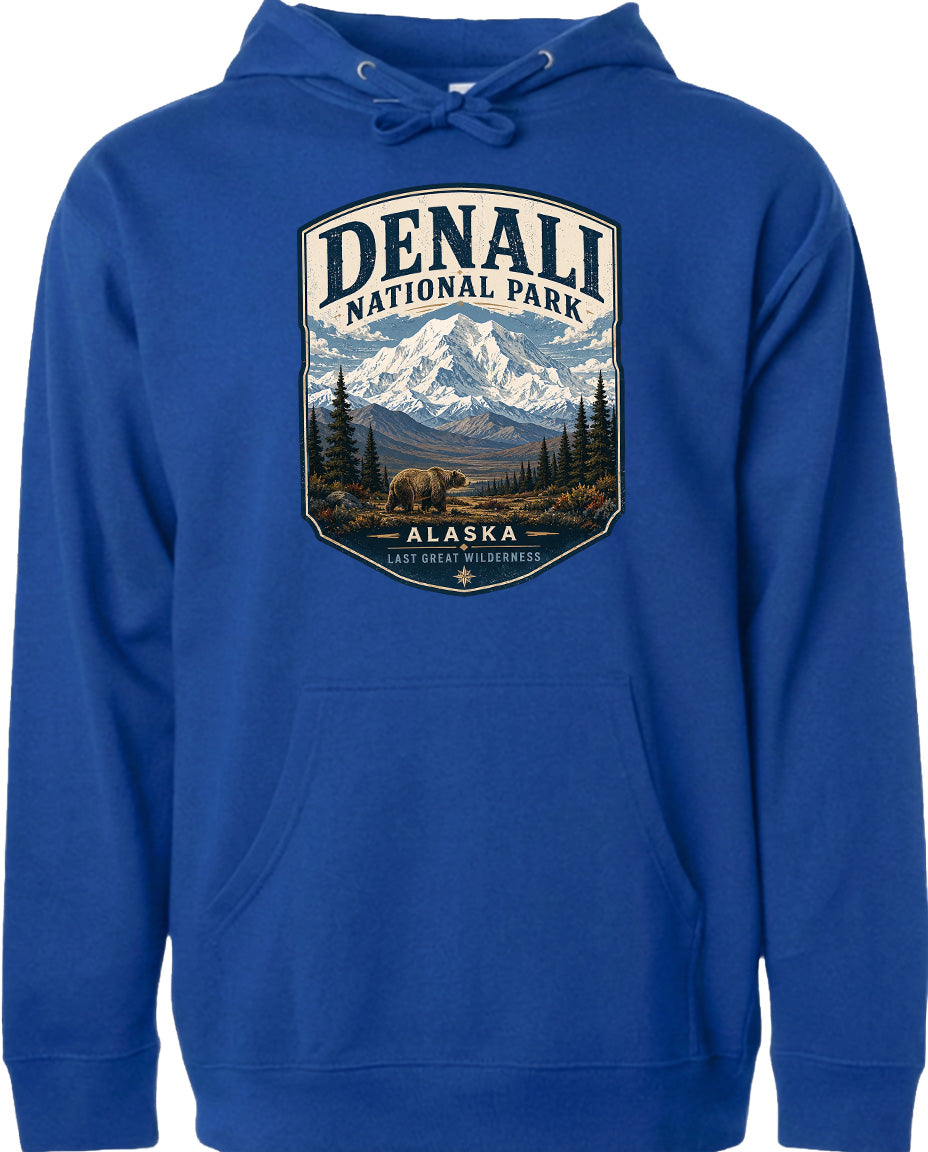 A blue hoodie with a graphic design depicting a mountain landscape and bears, along with the text "DENALI NATIONAL PARK ALASKA LAST GREAT WILDERNESS".