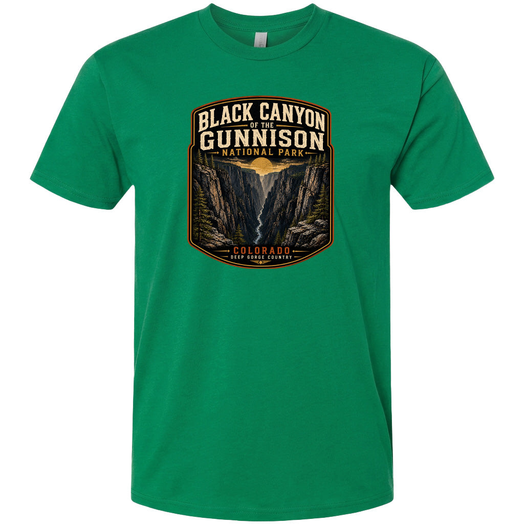 A green t-shirt with a graphic design depicting the Black Canyon of the Gunnison National Park in Colorado.