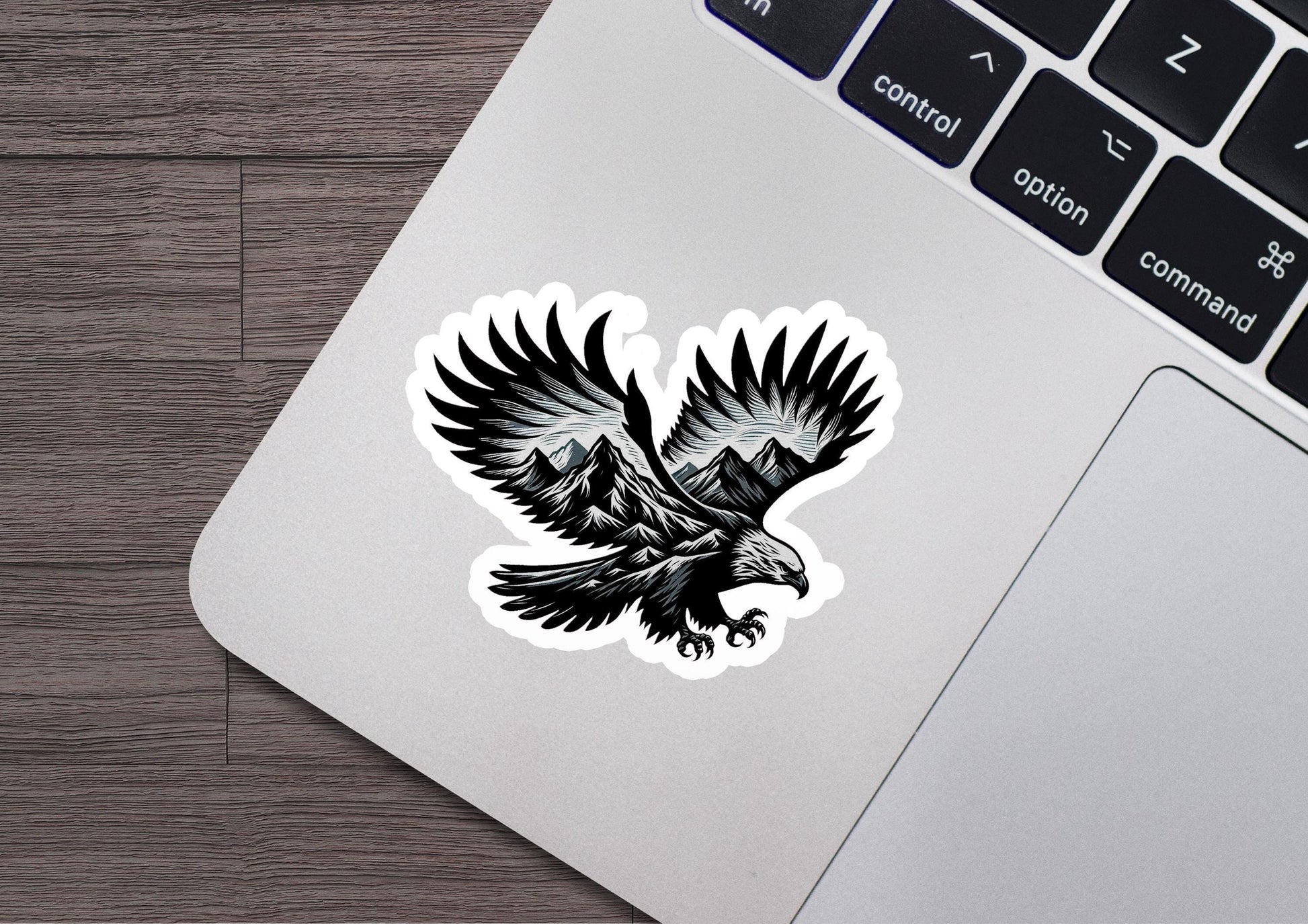 a sticker of an eagle with mountains in the background
