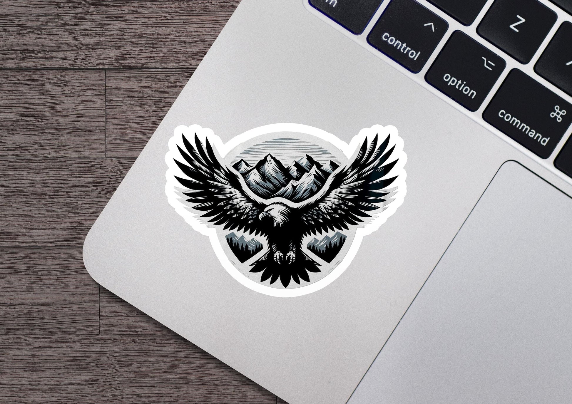 a sticker of an eagle with mountains in the background