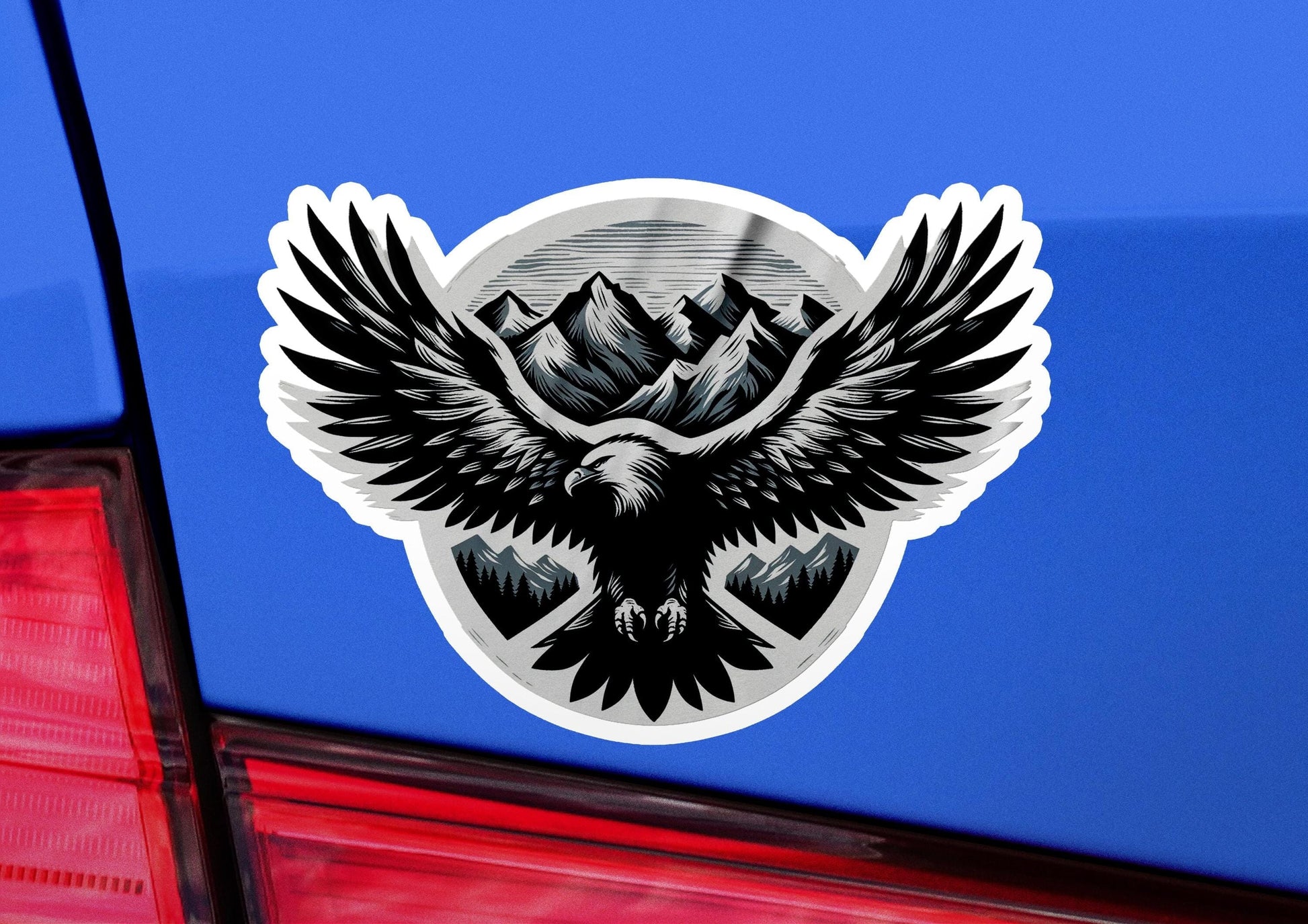 a sticker of an eagle with mountains in the background