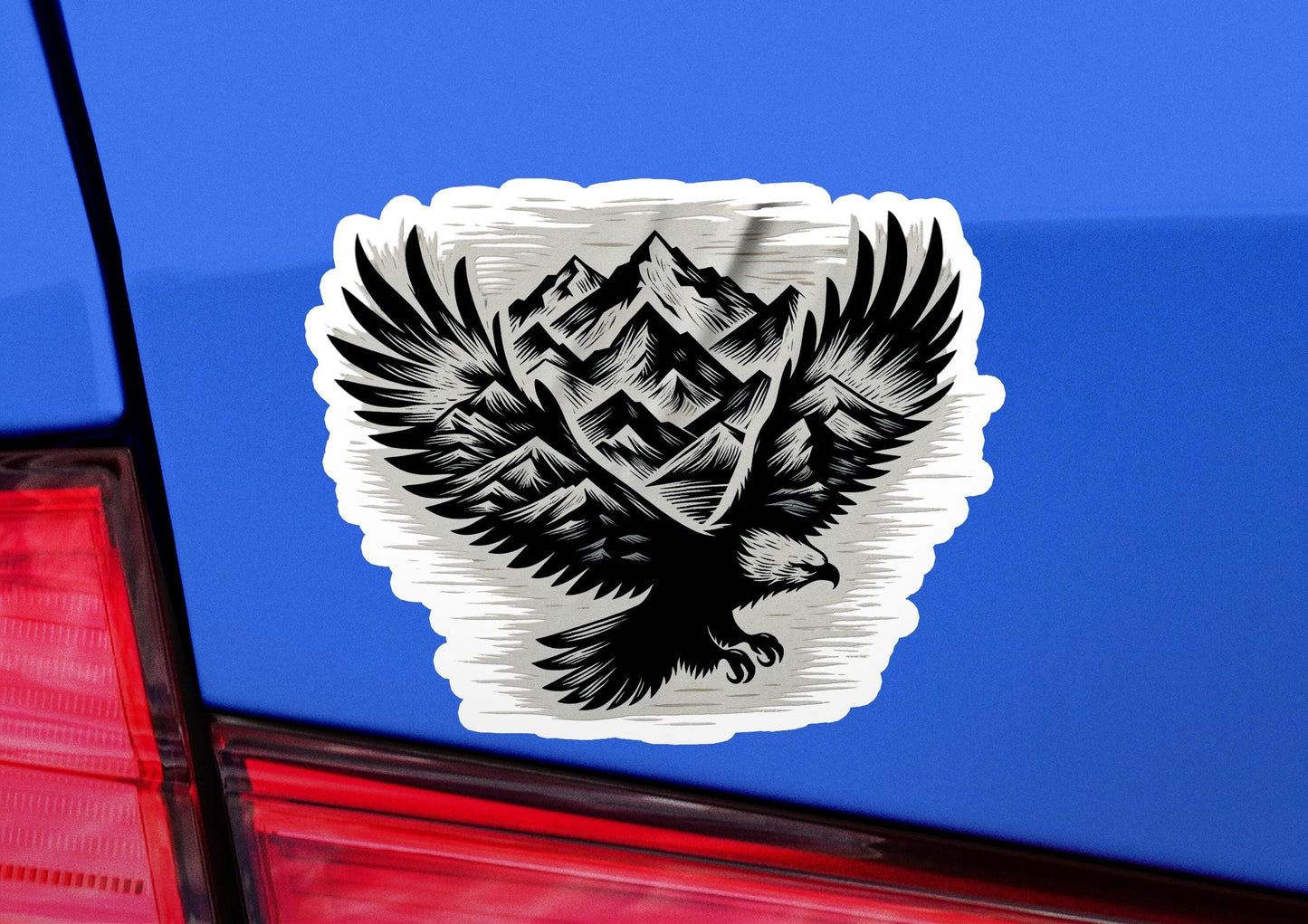 a sticker of an eagle with mountains in the background