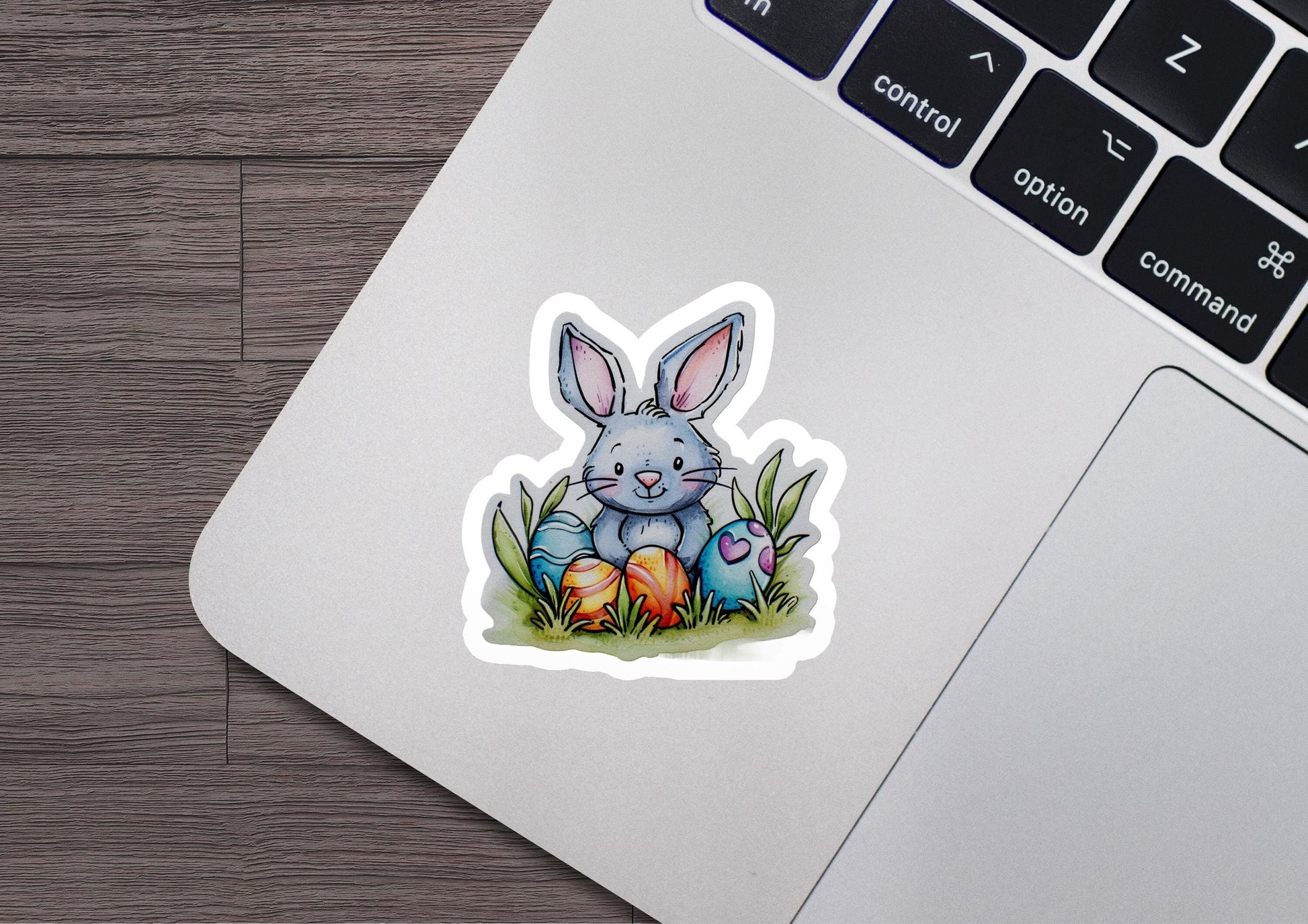 a laptop with a sticker of a bunny sitting on top of it