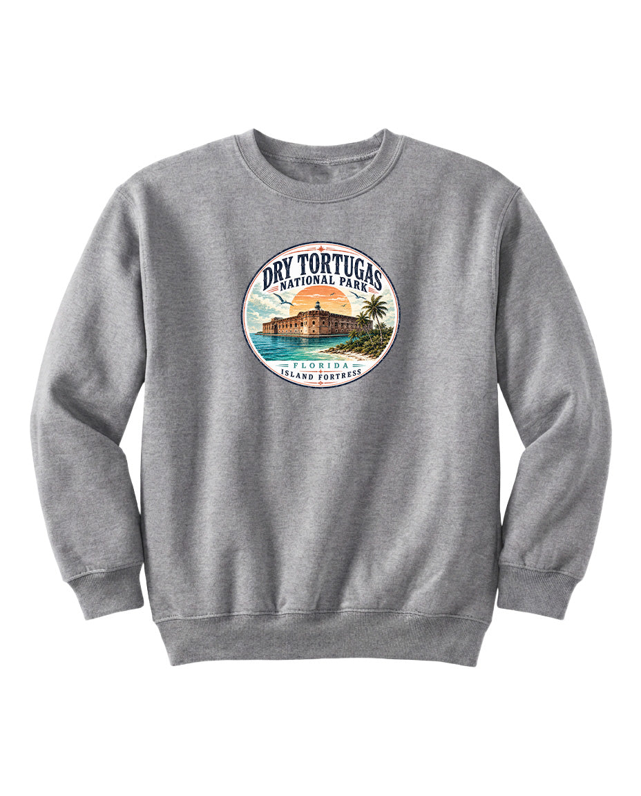 A gray sweatshirt with a circular logo featuring a beach scene and a building, representing Dry Tortugas National Park in Florida.