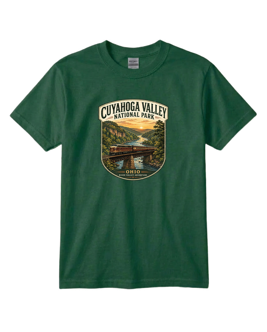 A green t-shirt with a graphic design depicting a scenic view of the Cuyahoga Valley National Park, featuring a bridge, river, and sunset landscape.