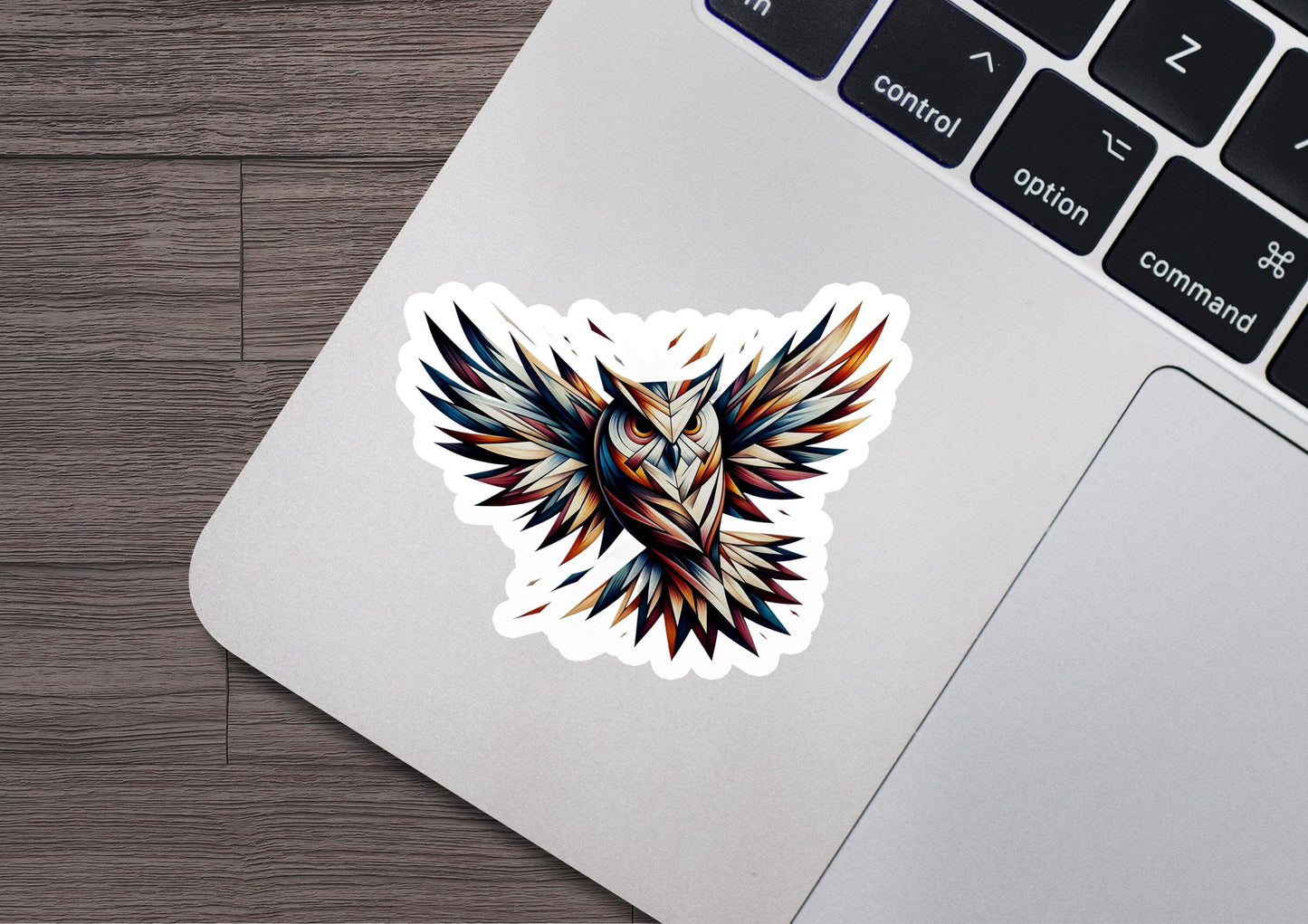 a laptop with a sticker of a bird on it