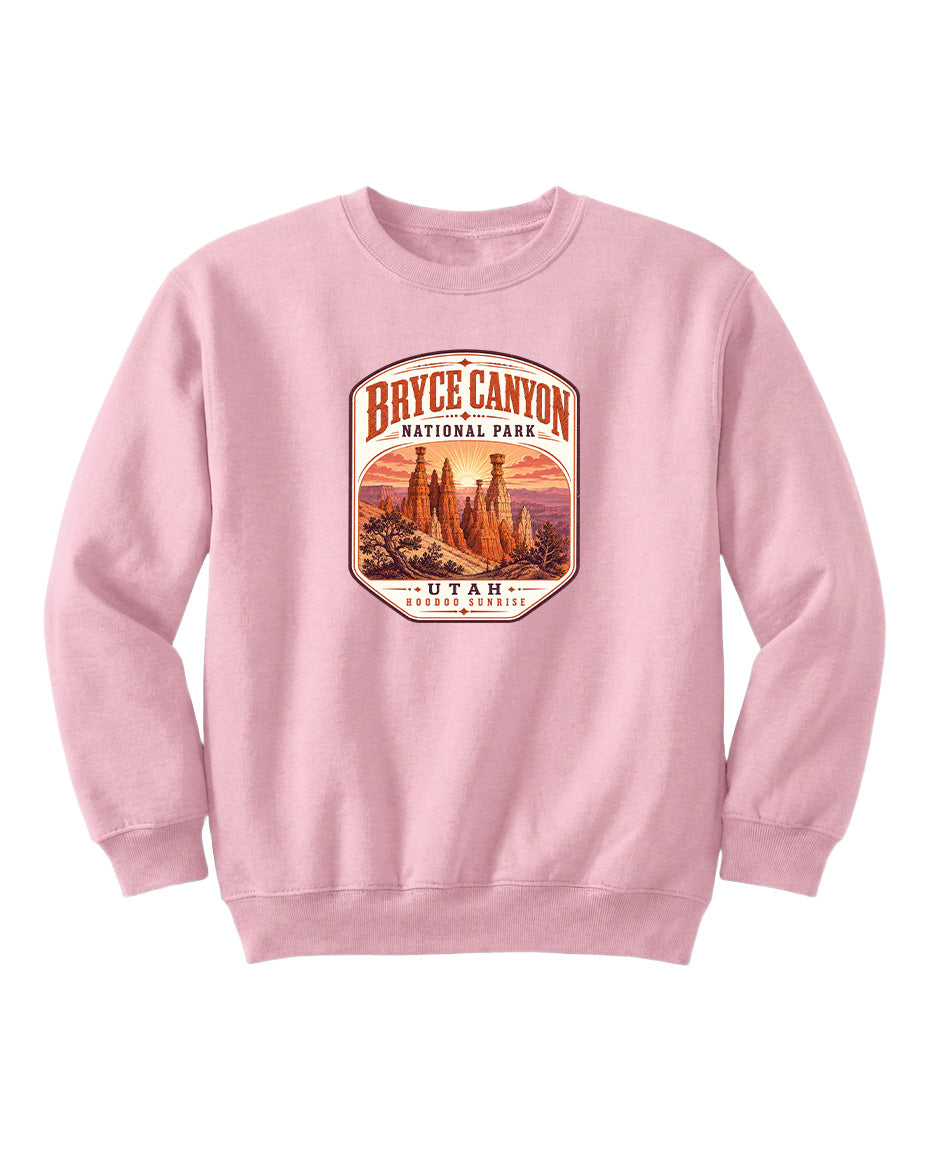 A pink sweatshirt with a graphic design depicting Bryce Canyon National Park and Utah.