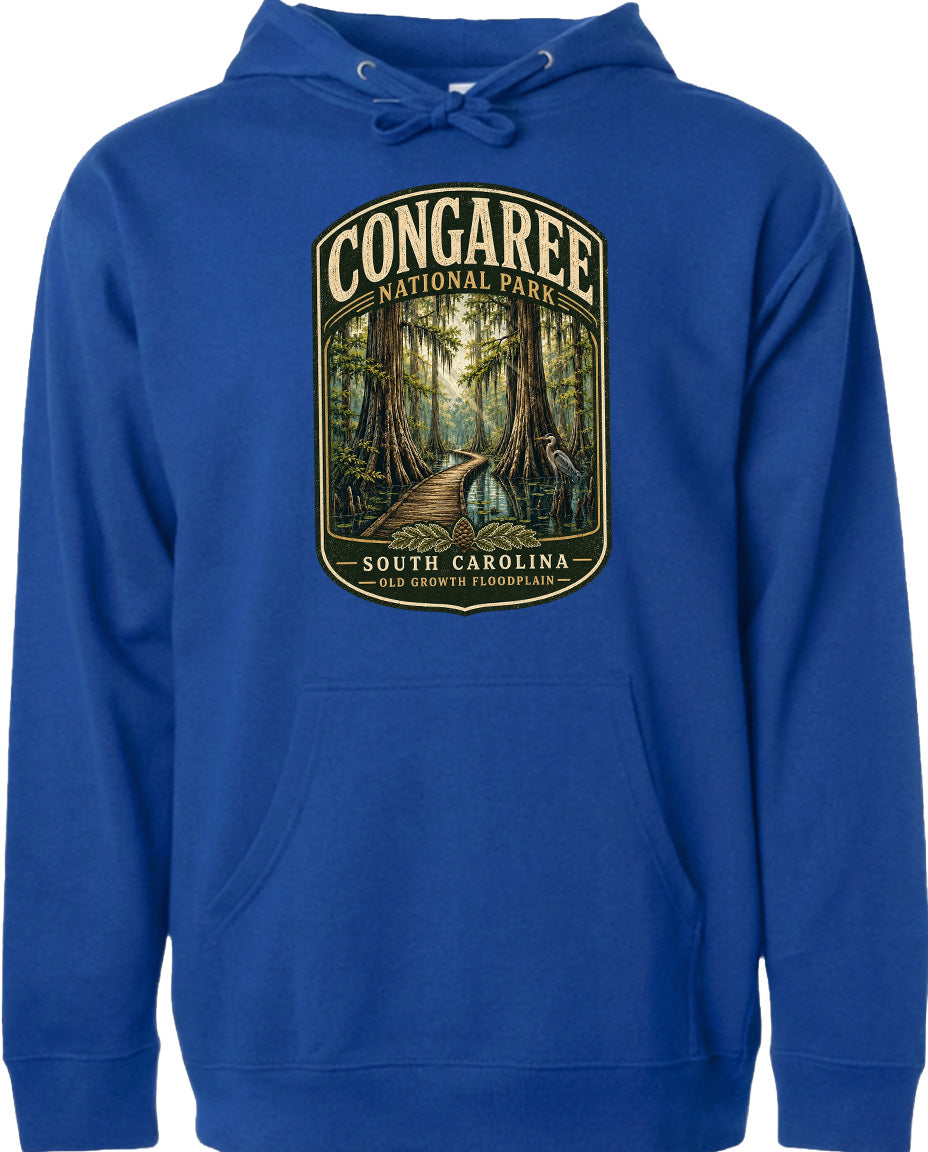 A blue hoodie with a graphic design depicting a forest path leading through Congaree National Park in South Carolina.