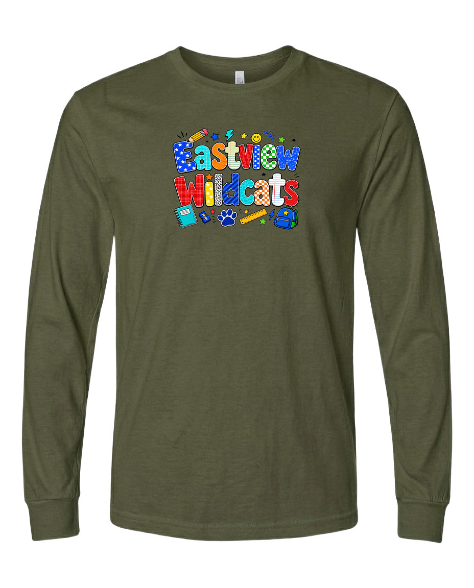 A long-sleeved olive green t-shirt with a colorful graphic design featuring the text "Eastview Wildcats" and various school supplies such as a pencil, eraser, and backpack.